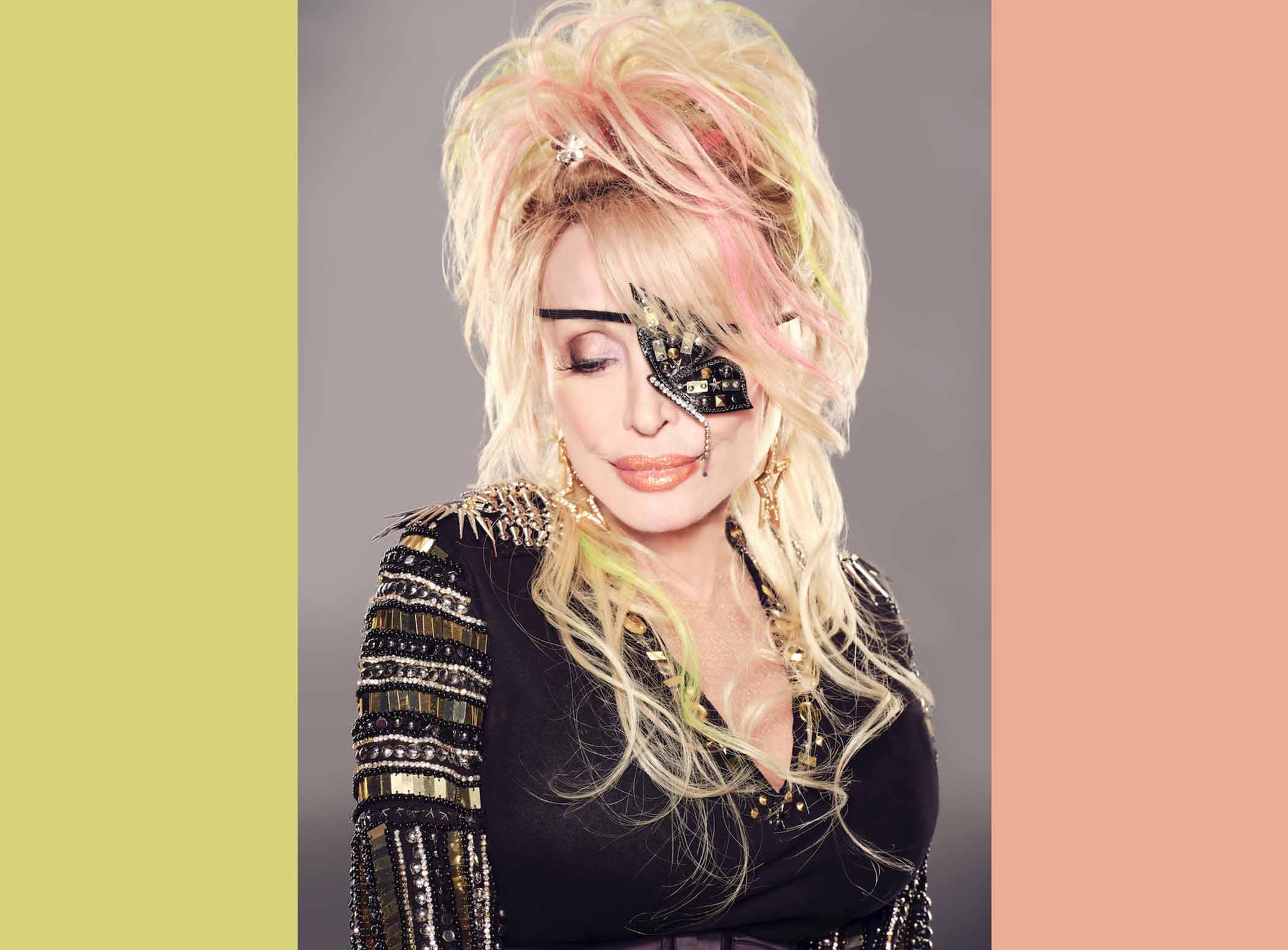 Dolly Parton in car with leopard pattern steering wheel; part of Village Voice article about her new rock album.