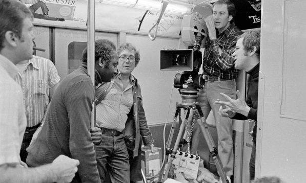 Straphangers: Director Joseph Sargent (center, with glasses) and cinematographer Owen Roizman prepare a close-up of a commuter having a very bad day in “The Taking of Pelham 123.”